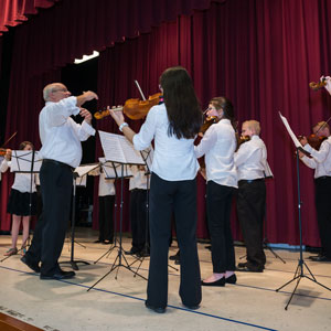 Image of Academy of Strings students playing violin for concert